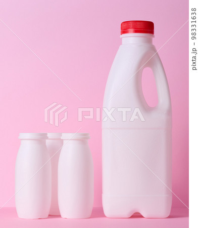 White plastic bottle for milk and dairy products on a pink background 98331638