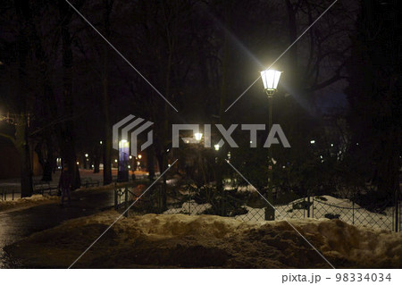 Burning lantern on the street in the park. Burning lantern on the street in the park. 98334034