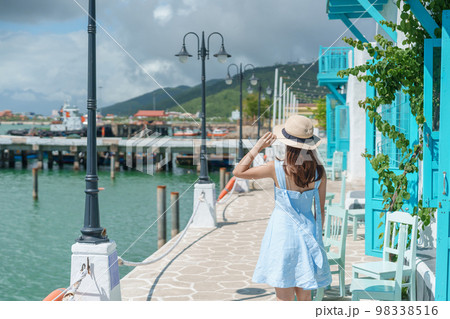 Woman traveler visiting at Son Tra marina. Tourist with blue dress and hat traveling in Da Nang city. Vietnam and Southeast Asia travel concept 98338516