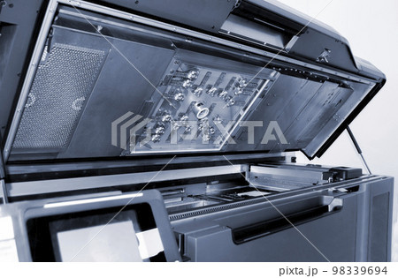 Top of large industrial printer with lid open. Multi Jet Fusion. Large industrial 3D printer printing polyimide powder. Industrial equipment. New modern 3D printing additive progressive technology MJF Top of large industrial printer with lid open. Multi Jet Fusion. Large industrial 3D printer printing polyimide powder. Industrial equipment. New modern 3D printing additive progressive technology MJF 98339694