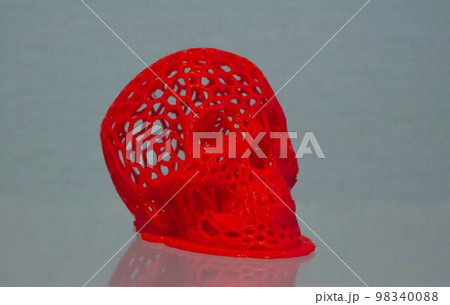 3D printed human skull prototype printed of red plastic close-up. 3D printed human skull prototype printed of red plastic close-up. 98340088