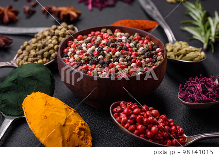 Variation of spices in metal spoons paprika, turmeric, cardamom, a mixture of allspice Variation of spices in metal spoons paprika, turmeric, cardamom, a mixture of allspice 98341015