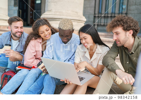 multicultural team of students looking at the laptop screen. multicultural team of students looking at the laptop screen. 98342158