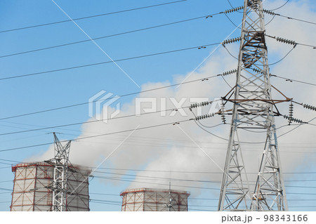 Smoke cooling tower pollution of the surrounding air environment of the atmosphere from the industrial plant and power lines high voltage tower Smoke cooling tower pollution of the surrounding air environment of the atmosphere from the industrial plant and power lines high voltage tower 98343166