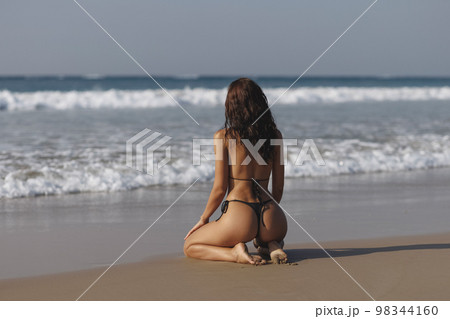 Fashion shot of a gorgeous young woman on the beach. Fashion shot of a gorgeous young woman on the beach. 98344160