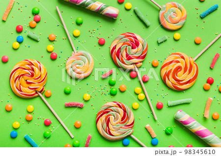 Tasty appetizing Party Accessories Happy Birthday Sweet. Different types of candies on colored background, copy space. Colorful birthday party background Tasty appetizing Party Accessories Happy Birthday Sweet. Different types of candies on colored background, copy space. Colorful birthday party background 98345610