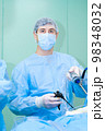 Portrait of a male surgeon in a mask and surgical uniform 98348032