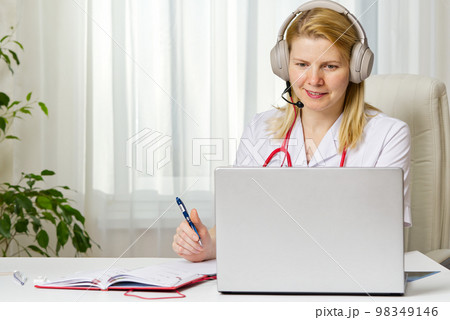 Online consultation doctor Virtual doctor visit telemedicine concept giving advice over laptop 98349146