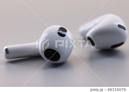 White headphones wireless headphones on gray background. 98350079
