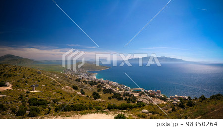 Landscape to the ionian sea from the top of Lekuresi Castle and military bunkers, Saranda, Albania 98350264