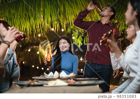 Young Asian people raising a toast at the party 98351083