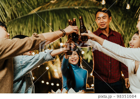 group of people celebrating outdoors by drinking beer group of people celebrating outdoors by drinking beer 98351084