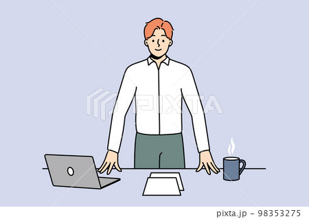 Smiling confident businessman at workplace Smiling confident businessman at workplace 98353275