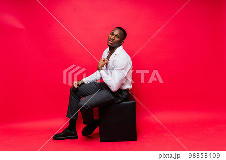 Smiling young african american man guy isolated on yellow background studio. People sincere emotions Smiling young african american man guy isolated on yellow background studio. People sincere emotions 98353409
