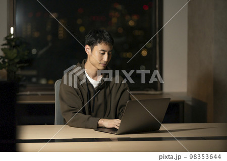 ノートパソコンで作業をする30代の男性　夜のオフィス　イメージ 98353644