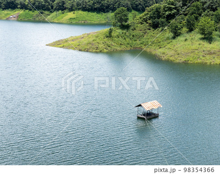 The water pump station is floating on the large reservoir of the dam. 98354366