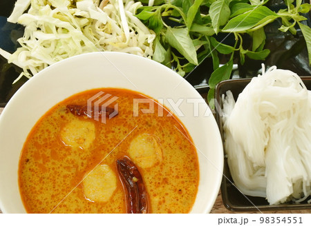 rice noodles on bowl with spicy fish curry sauce and fresh vegetable rice noodles on bowl with spicy fish curry sauce and fresh vegetable 98354551
