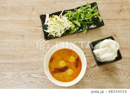 rice noodles on bowl with spicy fish curry sauce and fresh vegetable rice noodles on bowl with spicy fish curry sauce and fresh vegetable 98354554