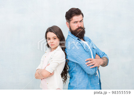 Daughter needs his unconditional love. Small daughter child and bearded man with serious look. Cute little daughter and father keeping arms crossed on grey background. Treating his daughter with love 98355559