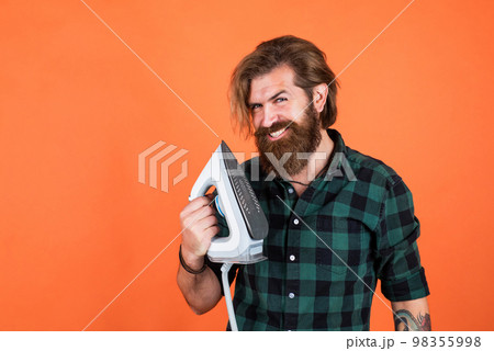 the smart choice. mature young man husband doing clothing ironing at home. hot and evaporation. modern life innovation. Man at home ironing clothes. happy house husband. Housekeeping 98355998