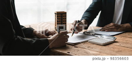 Real estate agent offer hand for customer sign agreement contract signature for buy or sell house. Real estate concept contact agreement concept. 98356603
