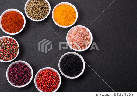 Composition consisting of a variation of several types of spices in white ceramic bowls Composition consisting of a variation of several types of spices in white ceramic bowls 98358955