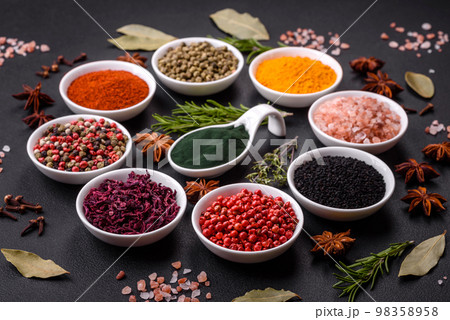 Composition consisting of a variation of several types of spices in white ceramic bowls Composition consisting of a variation of several types of spices in white ceramic bowls 98358958