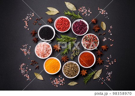 Composition consisting of a variation of several types of spices in white ceramic bowls Composition consisting of a variation of several types of spices in white ceramic bowls 98358970