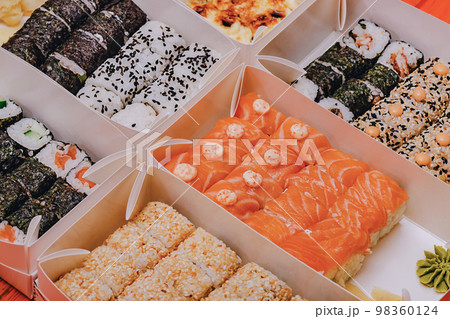 Various rolls in boxes. Food delivery Japanese cuisine. 98360124