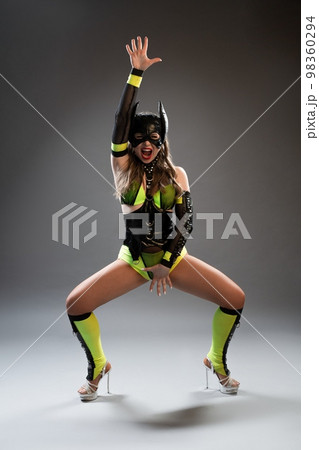 Sexy young lady in cat costume dancing in studio Sexy young lady in cat costume dancing in studio 98360294