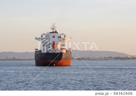 An industrial transport vessel sails on a river 98362606