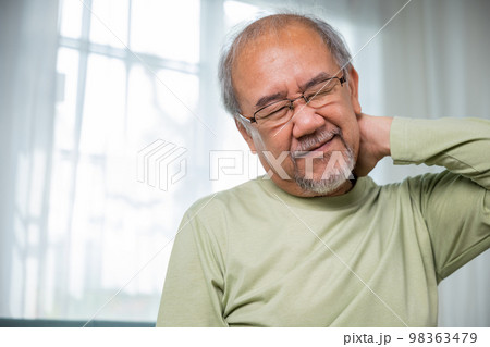 Old man suffering from nape neck pain at home, Elderly acute neckaches, Sad senior man neckache hand holding neck, Old age retirement health problems unhealthy diseased, shoulder pain 98363479