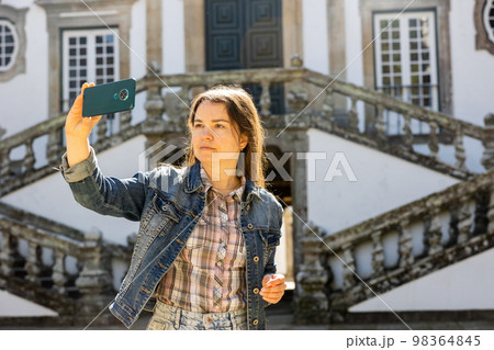 Woman tourist with phone, Vila Real, Portugal Woman tourist with phone, Vila Real, Portugal 98364845