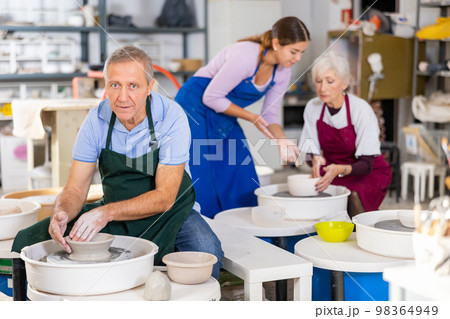 potter works on potter's wheel potter works on potter's wheel 98364949