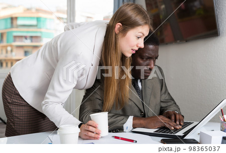 Female boss flirting with employee Female boss flirting with employee 98365037