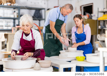 lady works on potter's wheel lady works on potter's wheel 98365066