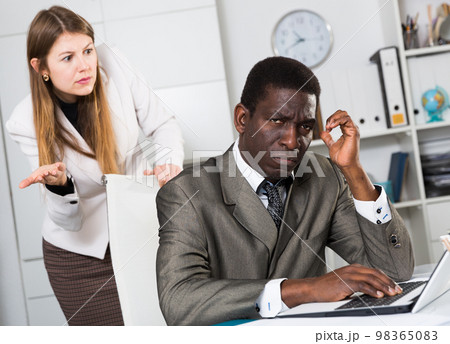 Upset man with angry boss 98365083
