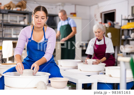girl works with potter`s wheel 98365163