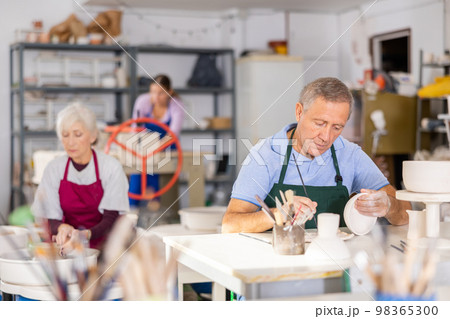 man potter carefully paints vase man potter carefully paints vase 98365300
