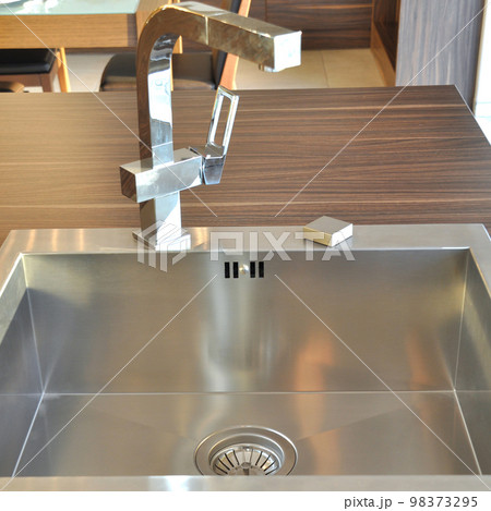 Interior of modern kitchen and stainless steel sink, tap and drain Interior of modern kitchen and stainless steel sink, tap and drain 98373295