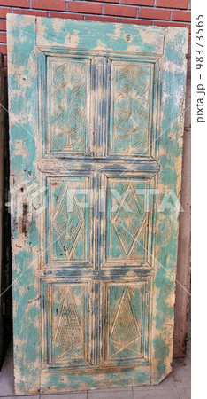 Traditional handmade wooden door in near plan Traditional handmade wooden door in near plan 98373565