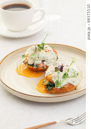 Portion of benedikt egg with dor-blue sauce Portion of benedikt egg with dor-blue sauce 98375510