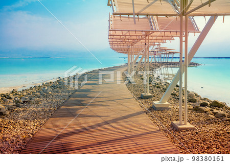 Seascape. The shore of the Dead Sea. Beach with a wooden walkway and sunshades. Summer. Israel 98380161