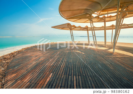Seascape. The shore of the Dead Sea. Beach with a wooden walkway and sunshades. Summer. Israel 98380162