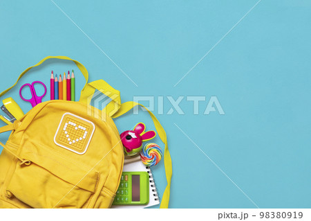 Back to school, education concept Yellow backpack with school supplies - notebook, pens, eraser rainbow, numbers isolated on blue background Top view Copy space Flat lay composition Banner. Back to school, education concept Yellow backpack with school supplies - notebook, pens, eraser rainbow, numbers isolated on blue background Top view Copy space Flat lay composition Banner. 98380919