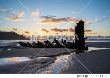 Wreck of Helvetia at sunset, Rhossili Bay beach, no people. Gower Peninsula, South Wales, the United Kingdom, UK GB. Wreck of Helvetia at sunset, Rhossili Bay beach, no people. Gower Peninsula, South Wales, the United Kingdom, UK GB. 98381199