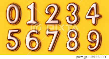 Metal numbers set on a yellow background. Top view. 98382081