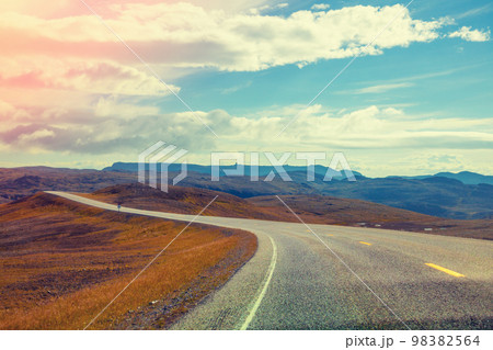 Driving a car on a mountain road. Beautiful harsh nature of Northern Norway 98382564