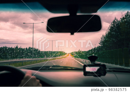 Driving on the Autobahn at sunset in rainy weather 98382575