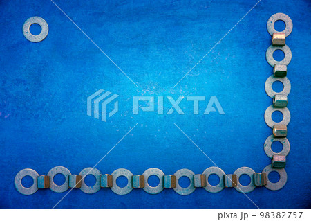 Abstract grunge background. Metallic rings washers on blue grunge wooden background Abstract grunge background. Metallic rings washers on blue grunge wooden background 98382757